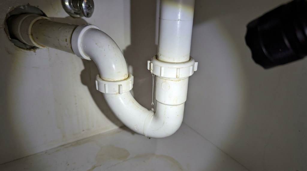 Leaking kitchen sink drain pipe under cabinet